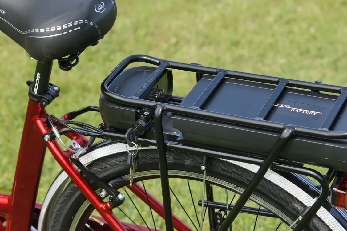 Rack-mounted electric bicycle battery with a locking key beneath a rear carrier.