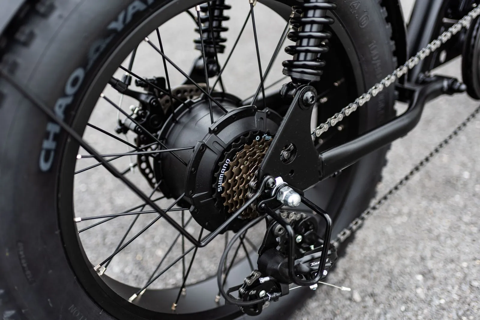 Close-up of an electric bicycle's rear hub motor, cassette and chain.